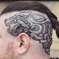 a man's head with a tattoo on the side of his head and a dragon