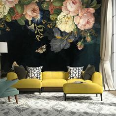 a living room with yellow couches and flowers on the wall behind it is a black background