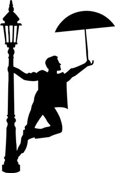 a man holding an umbrella while standing next to a lamp post