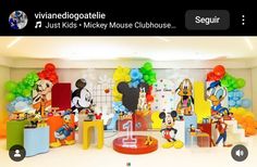 an image of mickey mouse birthday party with balloons on the wall and decorations in the background