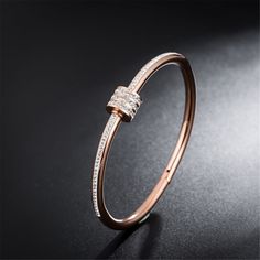 Add classic charm to your day when you slip on this sleek bangle plated with shimmering 18-karat gold and boasting a coil accent. 0.5'' W 18k rose gold-plated steel / cubic zirconia Rose Gold Cubic Zirconia Bangle, Elegant Rose Gold Stainless Steel Bracelet, Rose Gold Cubic Zirconia Bangle As Gift, Modern Rose Gold Stainless Steel Bangle, Rose Gold Metal Bangle, Rose Gold Diamond Bangle Bracelet, Rose Gold Metal Round Bangle, Rose Gold Stainless Steel Bangle Bracelet, Boho Wedding Jewelry