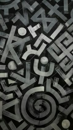 black and white photograph of abstract art with letters in the center, surrounded by circles