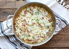 a casserole with meat and cheese in a pan on top of a towel