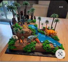 a birthday cake with dinosaurs and palm trees