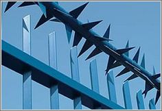 a metal fence with spikes sticking out of it