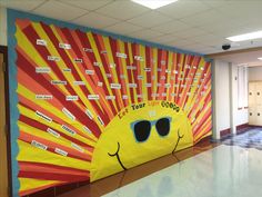 a bulletin board with sunglasses on it in an office hallway, next to a tiled floor