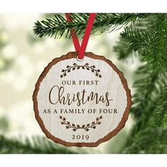 a wooden ornament hanging from a christmas tree with the words our first christmas as mommy and daddy