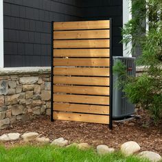 an air conditioner in front of a house with wood slats on the side