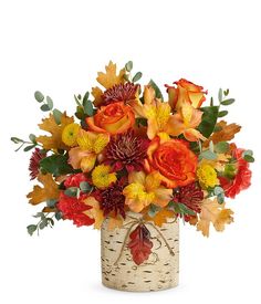 a vase filled with lots of colorful flowers