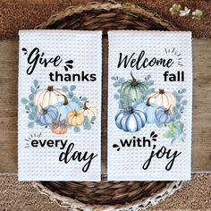 two white towels with pumpkins on them and the words give thanks, fall, and every day