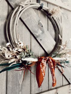 a wreath is hanging on the side of a wooden wall