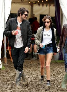 a man and woman walking in the mud