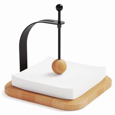 a wooden stand with a black and white object on it