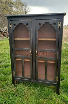 an old china cabinet is painted black