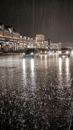 cars are driving through the rain at night