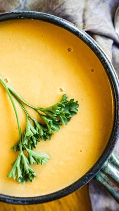 a bowl filled with soup and garnished with parsley