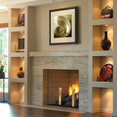 a living room filled with furniture and a fire place in front of a wall mounted fireplace