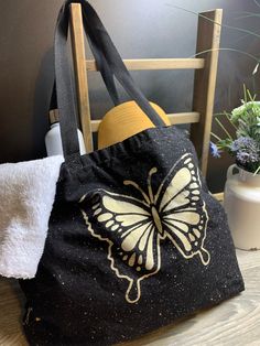 "Our Extra large 12 oz, 100% Heavy Cotton Canvas Distressed Butterfly Tote is the perfect accessory for trip to grocery, dog park or day trips. This 100% Cotton Canvas, Measures 19\" x 14\"x4\". 23\" Web Canvas Handle & 10\" Handle Drop with 4\" bottom gusset with simply bleached design. Machine washable canvas cold with like colors, iron. Want another design? We can add any of these bleach designs in our shop to your bag! Or you we can customize with your monogram, design, name or other text Pl Black Canvas Tote Bag With Eco-friendly Ink, Black Eco-friendly Canvas Tote Bag, Black Canvas Bag With Eco-friendly Ink For Everyday Use, Bleach Designs, Printed Canvas Tote Bag, Monogram Design, Dog Park, Custom Canvas, Black Canvas