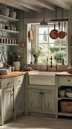 a kitchen filled with lots of pots and pans on top of a wooden counter