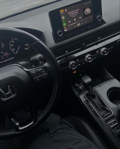 the interior of a car with an electronic display and steering wheel controls, dashboard lights, and dash board