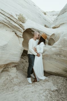 couple  kissing in white slot canyon at amangiri