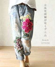 a woman's jeans with flowers painted on them and the words french written in chinese