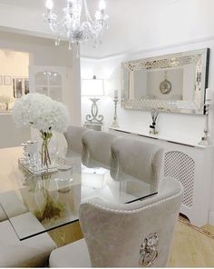 a dining room table with chairs and a chandelier