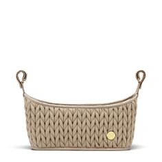 a beige purse with handles and braiding on the bottom, in front of a white background