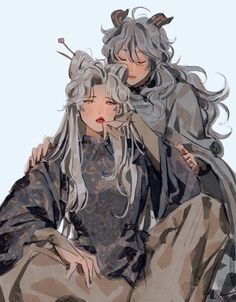 two people sitting next to each other with long hair and horns on their heads,