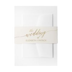 a wedding card with the word'the wedding'printed on it in gold ink