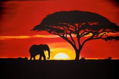 an elephant standing in front of a tree with the sun setting behind it and red sky