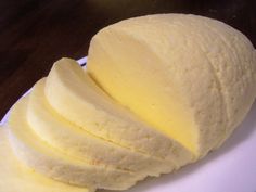 a white plate topped with sliced bananas on top of a wooden table