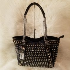 The Front And Sides Of This Dramatic Handbag Are Literally Covered In Alternating Columns Of Sparkling Rhinestones And Round, Polished Metal Stud. To Further Set The Tone, Feature Panels Are Trimmed With Square Metal Studs. The Effect Is Visually Stunning. Dual Carrying Straps 10 Inch Drop Length Zippered Top Opening Made Of Simulated Leather Construction Zippered Back Pocket Fully Lined Interior Includes Inside Zipper Pocket And Cell Phone Pouch Silver Toned Hardware. Fancy Handbags, Cell Phone Pouch, Phone Pouch, Zipper Top, Louis Vuitton Bag Neverfull, Womens Tote Bags, 10 Inch, Emboss, Blue And Silver