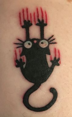 a black cat with red claws on it's head and eyes is depicted in this tattoo