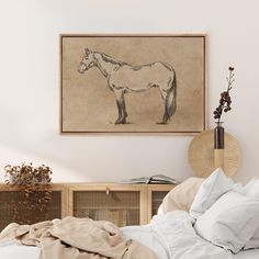 a bedroom with a horse drawn on the wall above it and a bed covered in white sheets