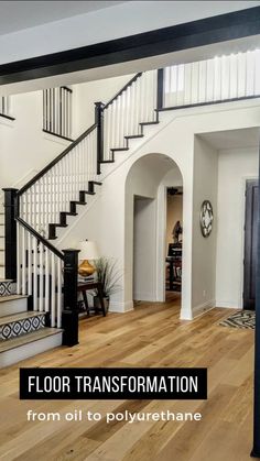 an open floor plan with white walls and black railings on the second story stairs