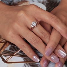 a woman's hand with a diamond ring on it