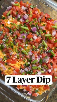 the seven layer dip is made with tomatoes, onions, green peppers and other veggies