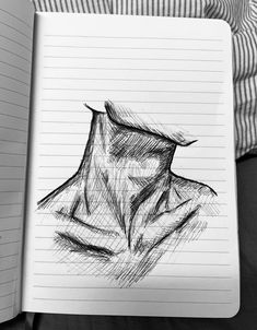 a drawing of a man's head in a notebook