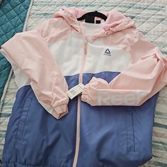 Brand New Multi Color Reebok Hooded Jacket Size Xl Casual Pink Windbreaker With Adjustable Hood, Pink Hooded Windbreaker With Drawstring, Blue Moisture-wicking Hooded Windbreaker, Pink Double-lined Hooded Jacket For Sports, Pink Double-lined Hood Sports Outerwear, Womens Reebok, Hooded Jacket, Pink Blue, Coats For Women