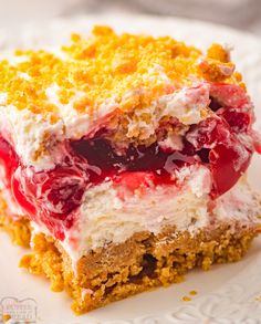 two pieces of cake on a plate with crumbled toppings and cherries