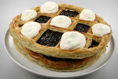 two waffles on a plate topped with whipped cream