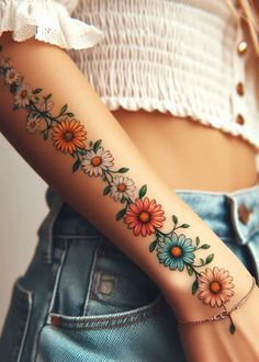 a woman's arm with flowers on it