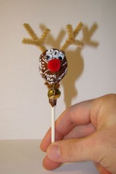 a hand holding a candy bar with reindeer noses on it and the words tootsie pop reindeer