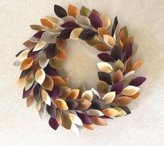 a wreath made out of different colored leaves