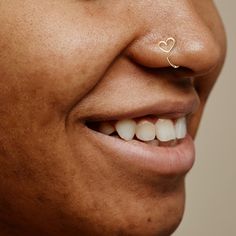 a man with a nose piercing in the shape of a heart