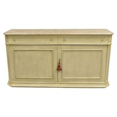 a white cabinet with two doors and drawers