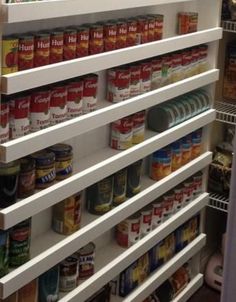 an organized pantry with canned food in it