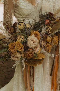 a bride holding a bouquet of flowers in her hands