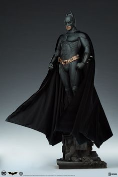 the batman statue is on display in front of a dark background